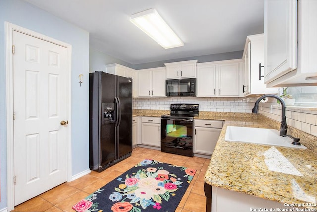 kitchen featuring light tile patterned flooring, a sink, white cabinets, decorative backsplash, and black appliances