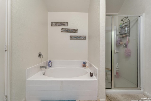 bathroom with a shower stall and a bath