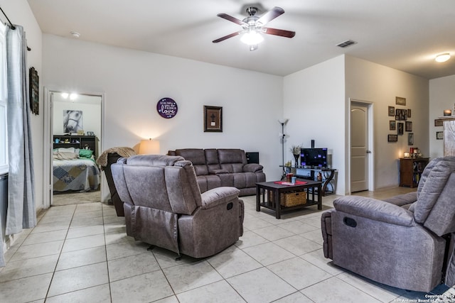 living room featuring light tile patterned floors, ceiling fan, and visible vents