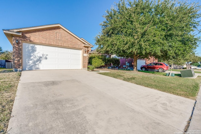 view of front facade with a garage, central AC, brick siding, concrete driveway, and a front yard