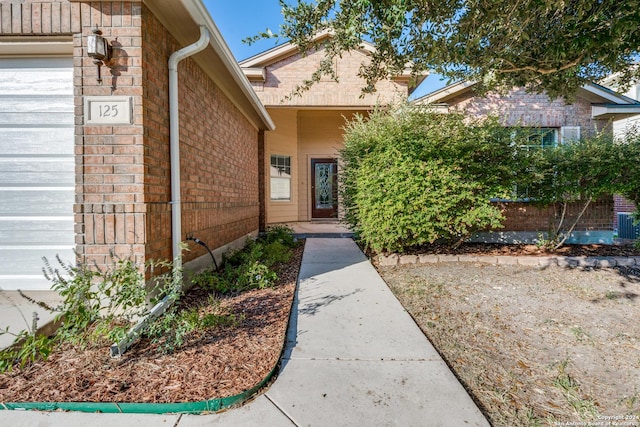 view of exterior entry with brick siding