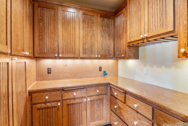 kitchen featuring tasteful backsplash and brown cabinets