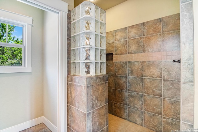 interior details with walk in shower and baseboards