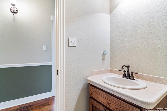bathroom featuring vanity and wood finished floors