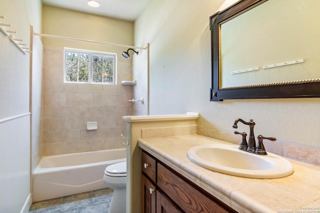 bathroom featuring toilet, shower / bathtub combination, and vanity