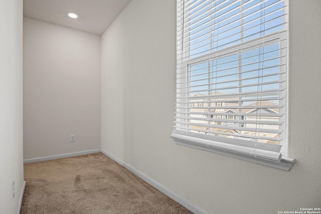 carpeted spare room with baseboards