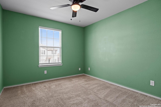 empty room featuring carpet, baseboards, and ceiling fan