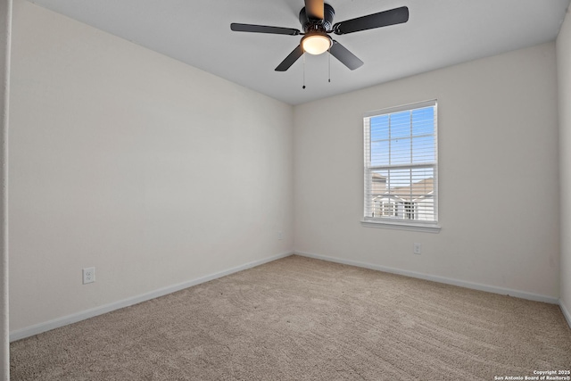 carpeted empty room with baseboards and a ceiling fan