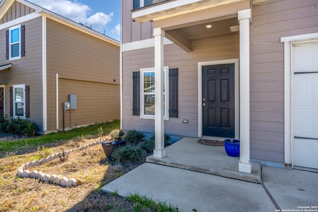 entrance to property featuring a garage and board and batten siding