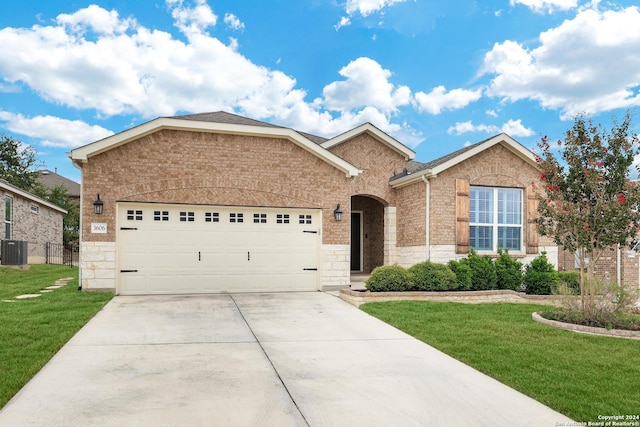 ranch-style house with a garage, stone siding, a front lawn, and concrete driveway