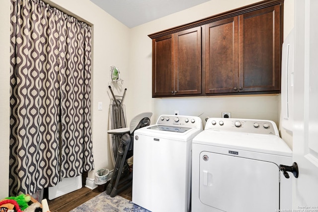 clothes washing area featuring separate washer and dryer, dark wood finished floors, cabinet space, and baseboards