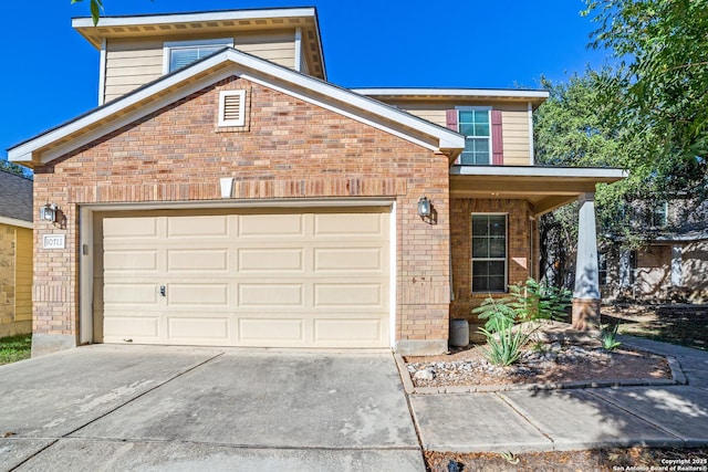 traditional-style house featuring driveway, brick siding, and an attached garage