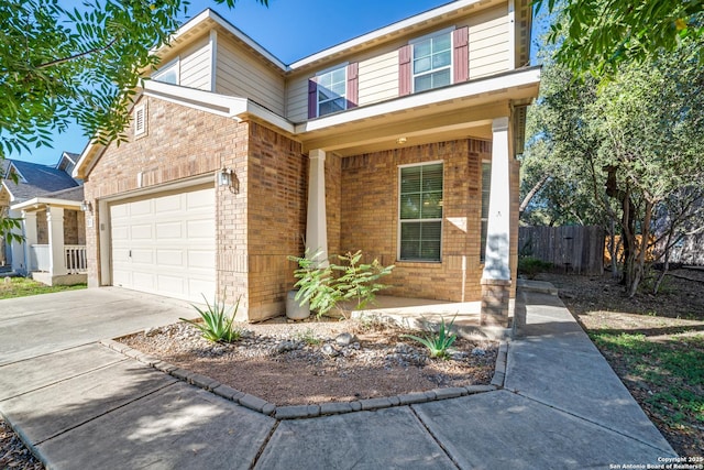 traditional-style house featuring driveway, a garage, covered porch, fence, and brick siding