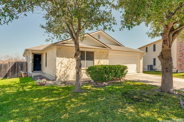 ranch-style house featuring an attached garage, fence, driveway, stone siding, and a front lawn