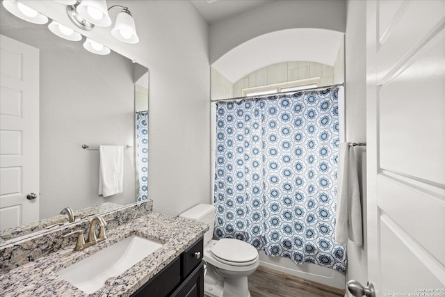 full bath featuring vanity, wood finished floors, and toilet