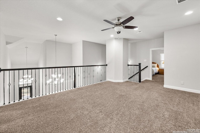 carpeted empty room with recessed lighting, visible vents, baseboards, and ceiling fan with notable chandelier