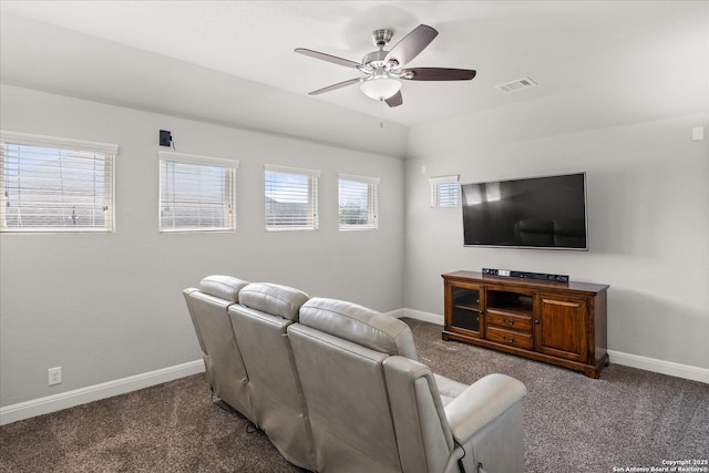 carpeted living area with ceiling fan, vaulted ceiling, visible vents, and baseboards