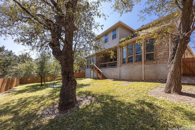 view of yard with stairs and a fenced backyard