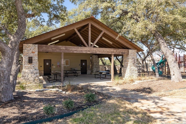 view of home's community featuring playground community, a patio area, and fence