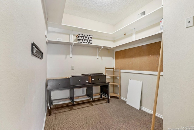 interior space with visible vents, a textured ceiling, and baseboards