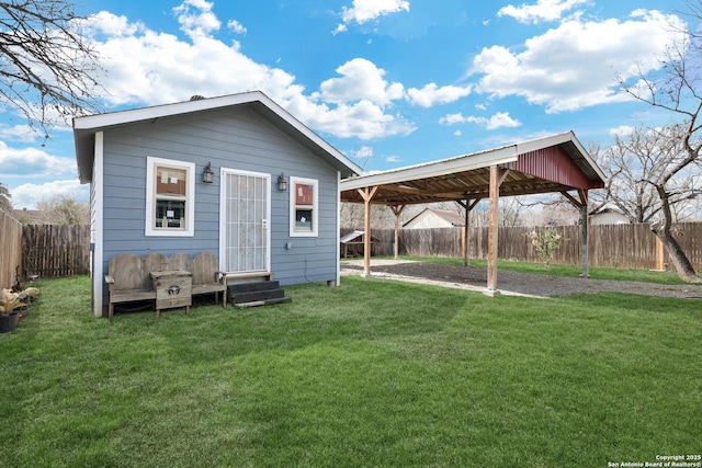 exterior space with entry steps, an outdoor structure, and a fenced backyard