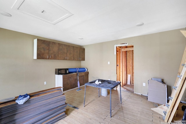 home office with attic access and light wood finished floors