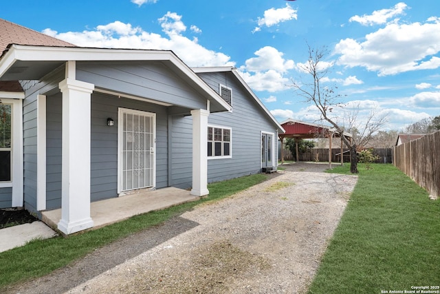 exterior space featuring a patio area, a fenced backyard, and a front yard