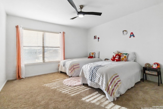 bedroom with carpet floors, a ceiling fan, and baseboards