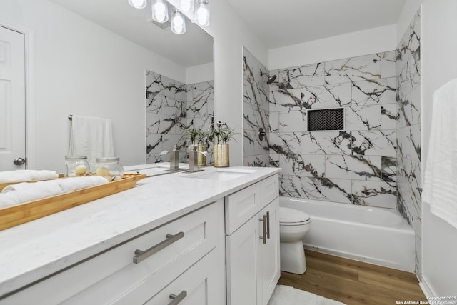 full bathroom featuring  shower combination, vanity, toilet, and wood finished floors