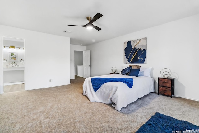 bedroom with carpet, connected bathroom, visible vents, and a ceiling fan