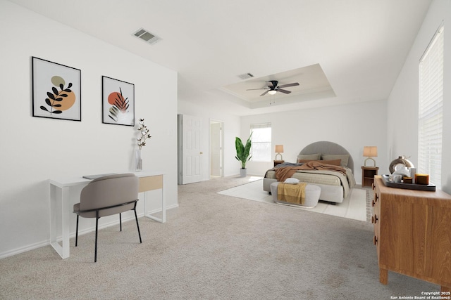 bedroom with carpet, visible vents, a raised ceiling, and baseboards