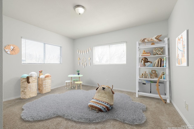 rec room featuring carpet flooring and baseboards