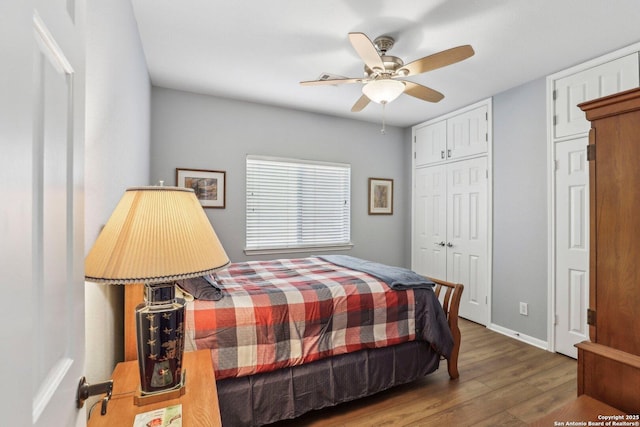 bedroom featuring ceiling fan, baseboards, and wood finished floors