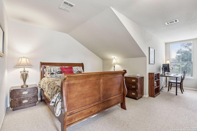 carpeted bedroom with vaulted ceiling, visible vents, and baseboards