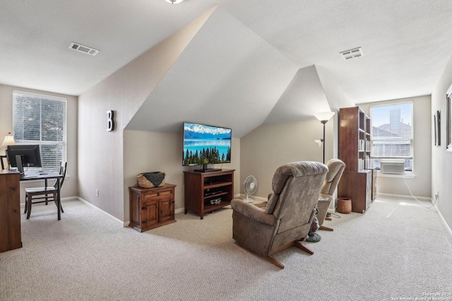 interior space with lofted ceiling, carpet floors, visible vents, and baseboards