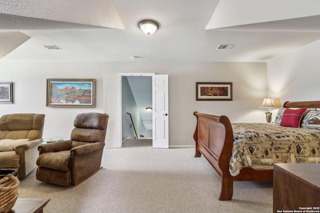 carpeted bedroom featuring visible vents