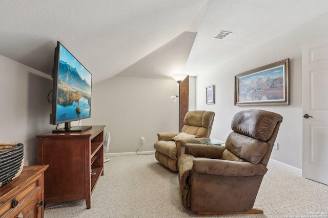 interior space featuring baseboards, vaulted ceiling, visible vents, and light colored carpet