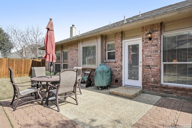 view of patio / terrace with grilling area, fence, and outdoor dining area