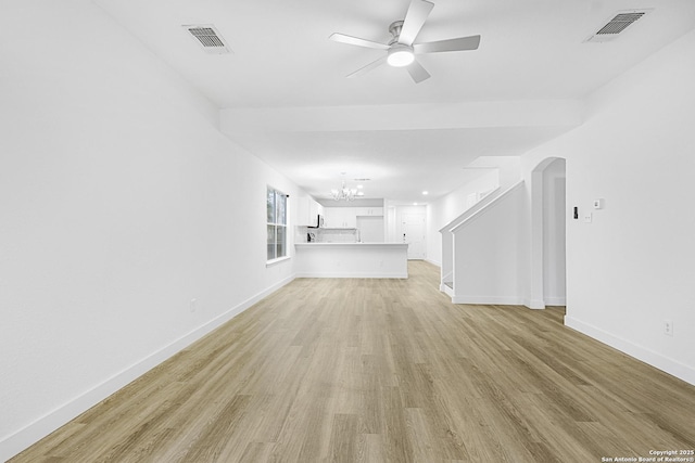 unfurnished living room with light wood-style floors, baseboards, and visible vents