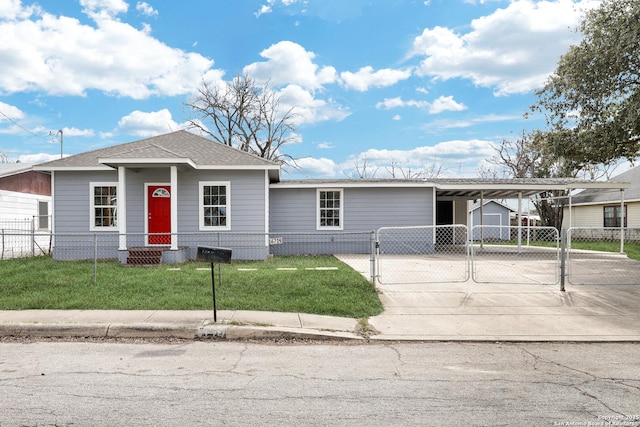 view of front of house with an attached carport, a fenced front yard, driveway, a gate, and a front yard