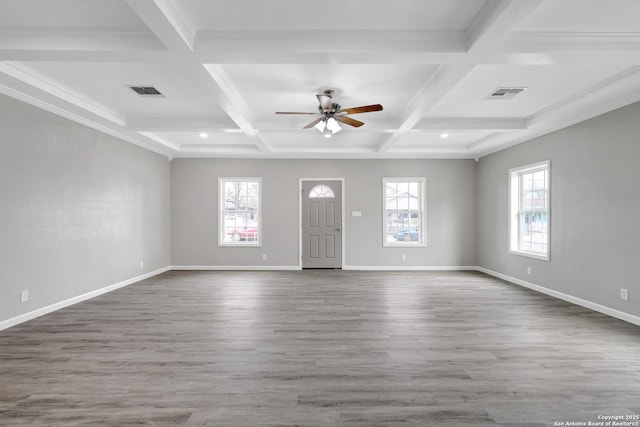 entrance foyer featuring a wealth of natural light, visible vents, baseboards, and wood finished floors