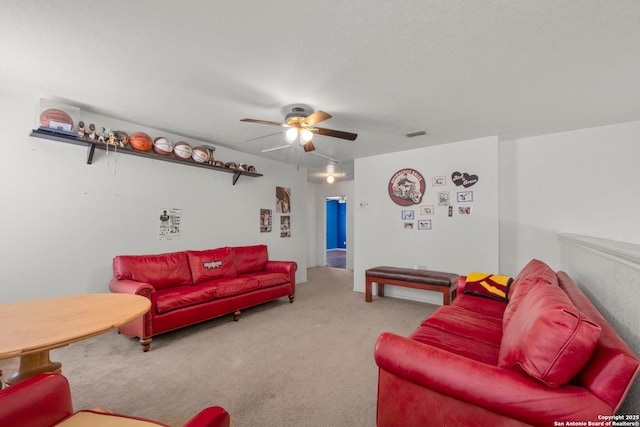 carpeted living area featuring ceiling fan and visible vents