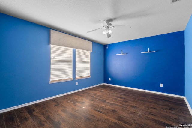 unfurnished room with ceiling fan, a textured ceiling, baseboards, and wood finished floors