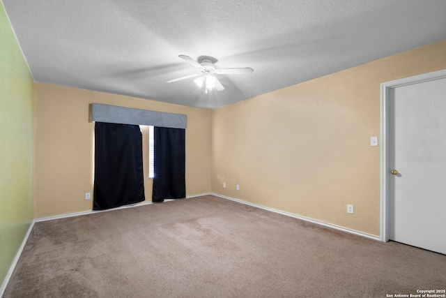 unfurnished room with carpet floors, a textured ceiling, and baseboards