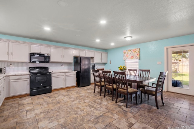 kitchen with black appliances, tasteful backsplash, recessed lighting, and stone finish flooring