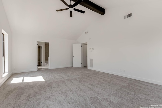 interior space with baseboards, visible vents, beamed ceiling, and light colored carpet