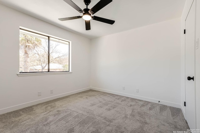 unfurnished room featuring baseboards, a ceiling fan, and light colored carpet