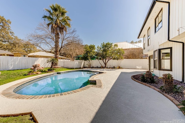 view of swimming pool featuring a fenced in pool, a fenced backyard, and a patio