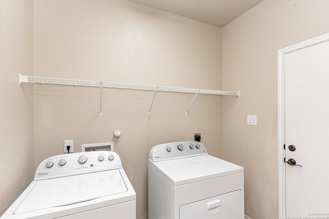 clothes washing area featuring laundry area and washing machine and dryer