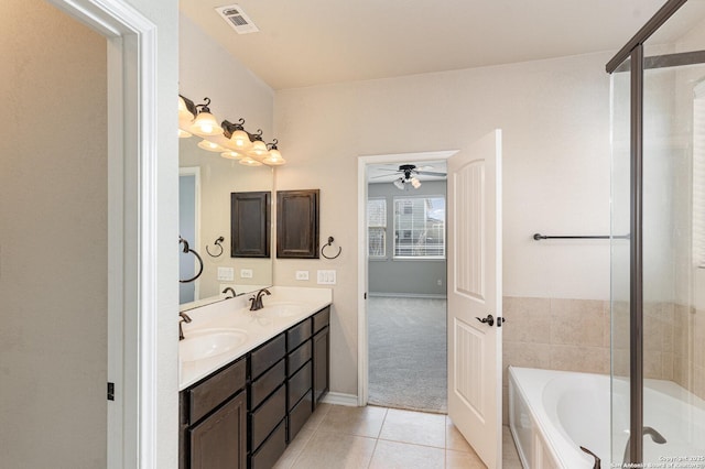 bathroom with a bath, tile patterned flooring, a sink, and visible vents